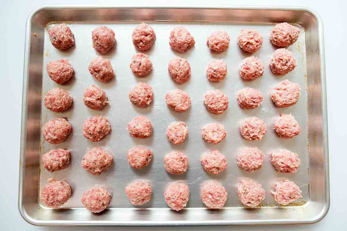 Formed Swedish meatballs resting on a baking dish