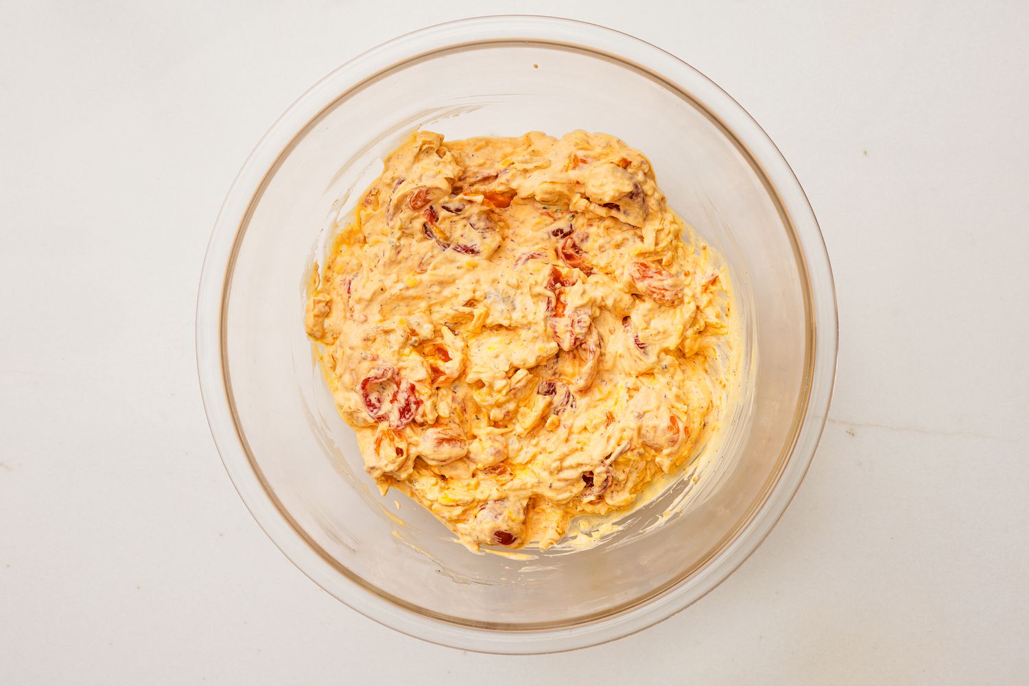 tomato pie dip ingredients mixed together in a bowl for tomato pie dip recipe