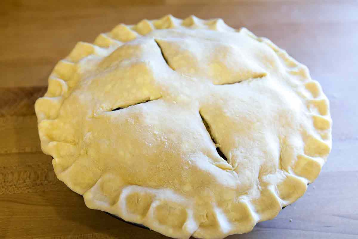score the top of the apple pie and brush with an egg wash