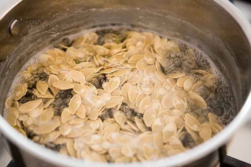 Pumpkin seeds boiling in a pot
