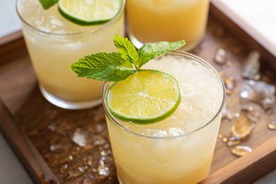 What's in a Mai Tai? closeup peach orange cocktail with lime and mint garnish