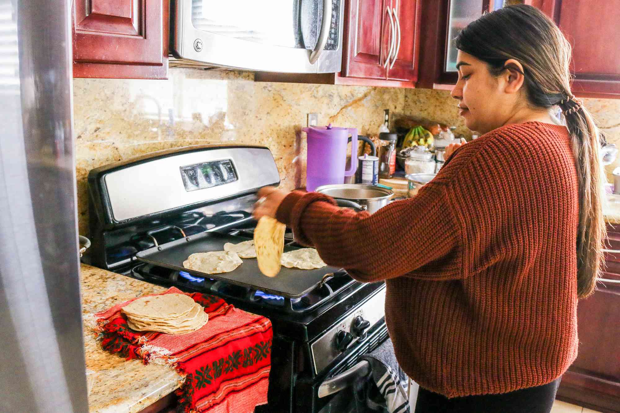 Heating tortillas on the stove inside