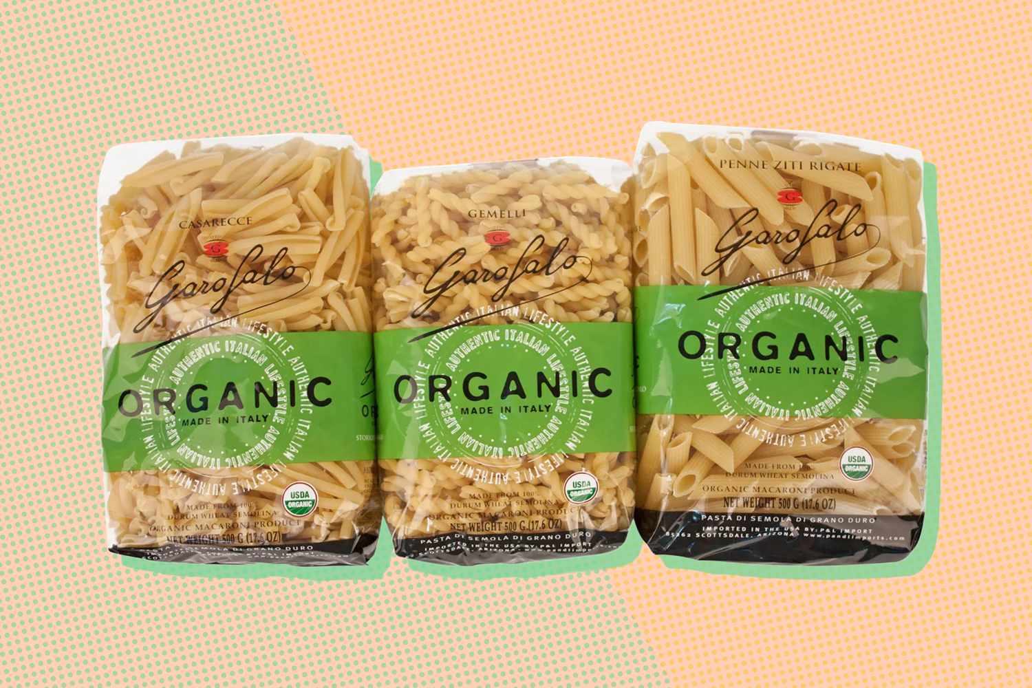 Three packages of organic pasta of different shapes displayed in a row