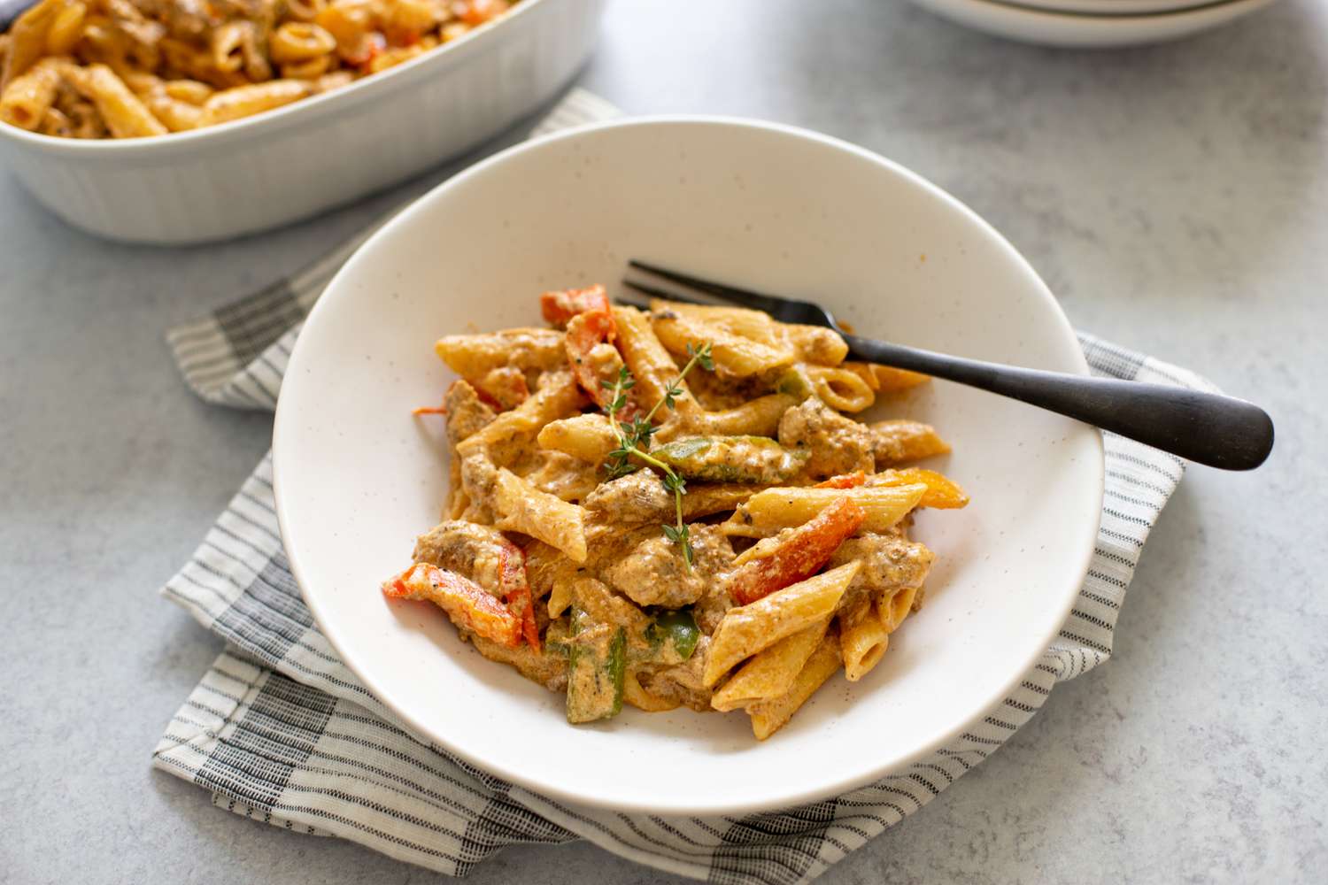 Rasta Pasta with Jerk Chicken in a Bowl with a Fork