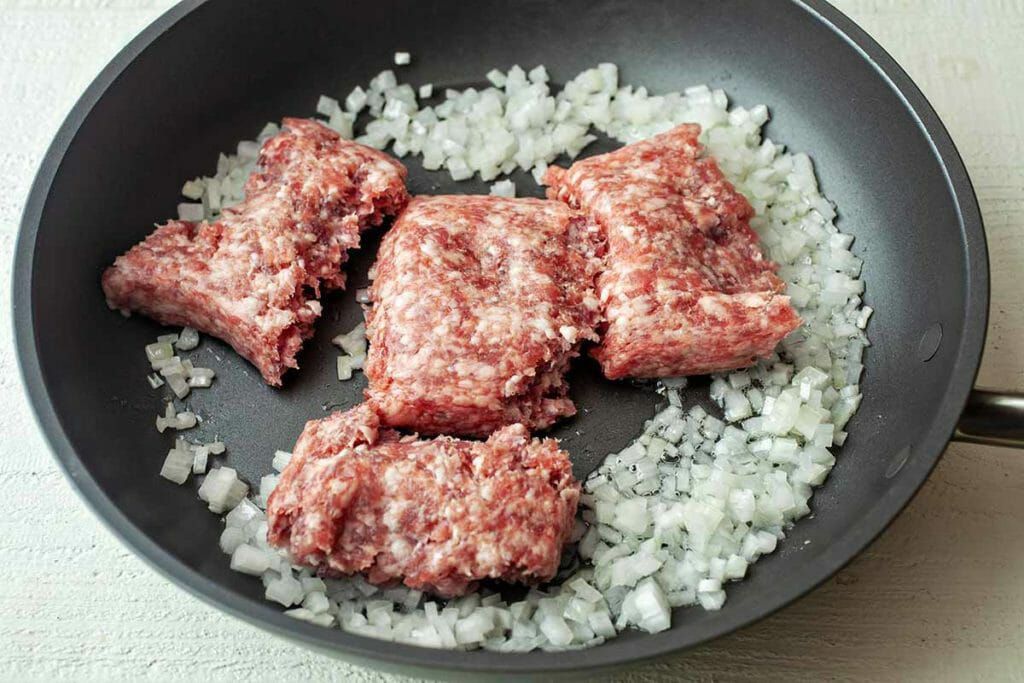 Easy Rice Bowl Recipe with Pork - raw pork and onions cooking in pan