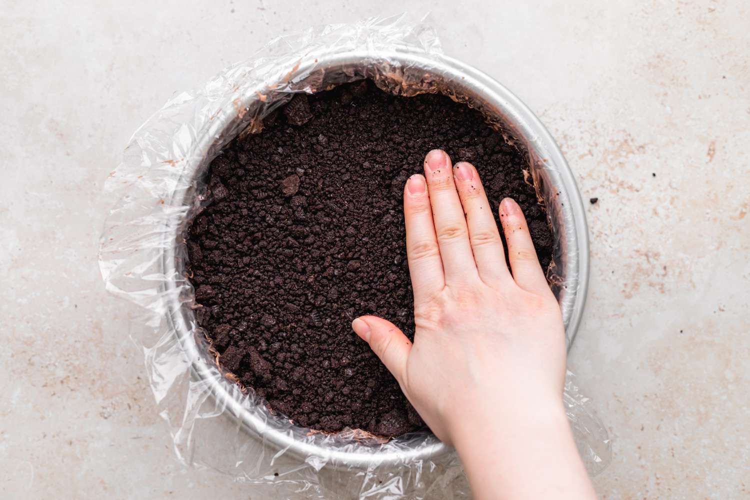 Chocolate Crumb Layer Added to Pan for Ice Cream Cake Recipe