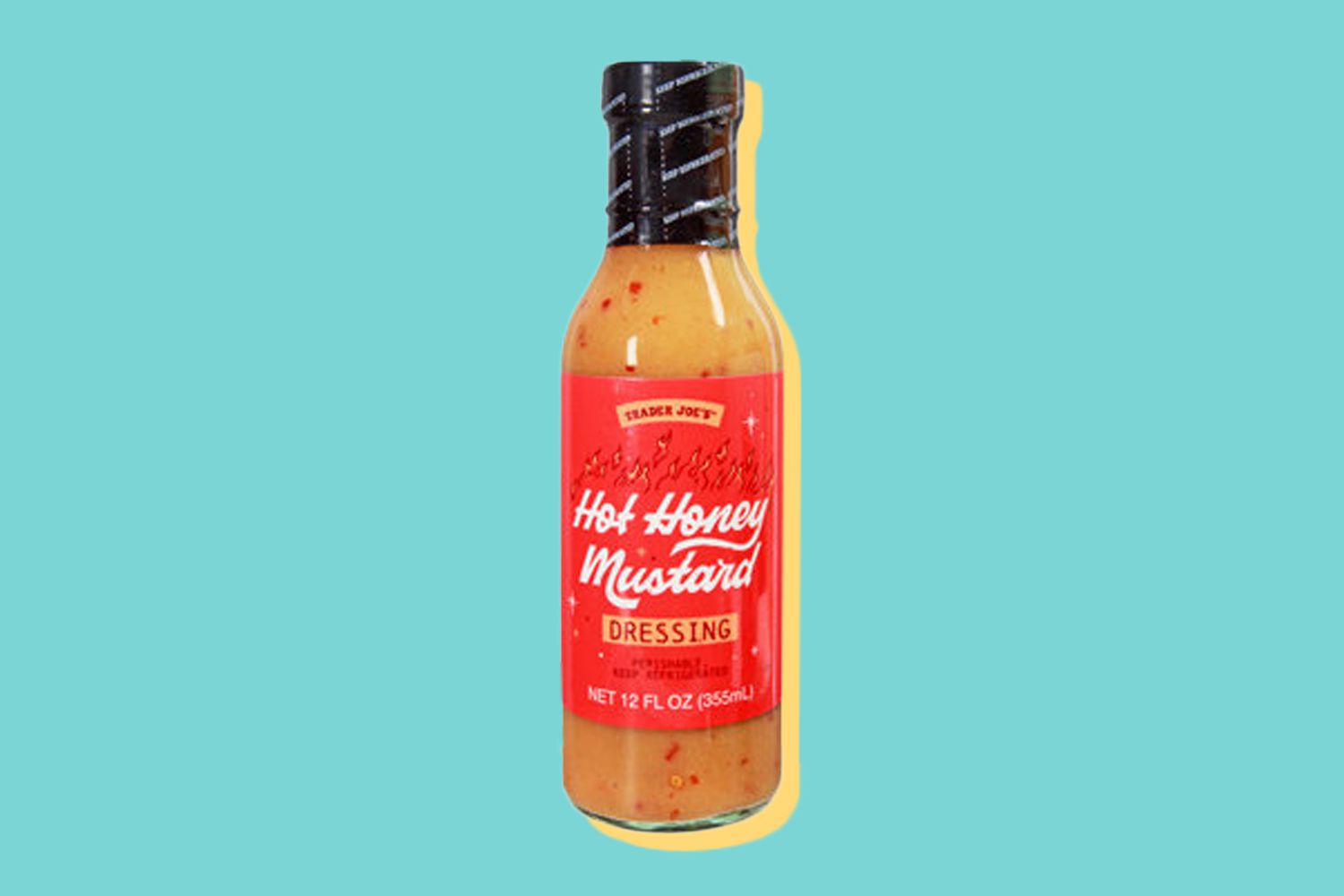 Bottle of Trader Joe's hot honey mustard dressing in front of a blue background