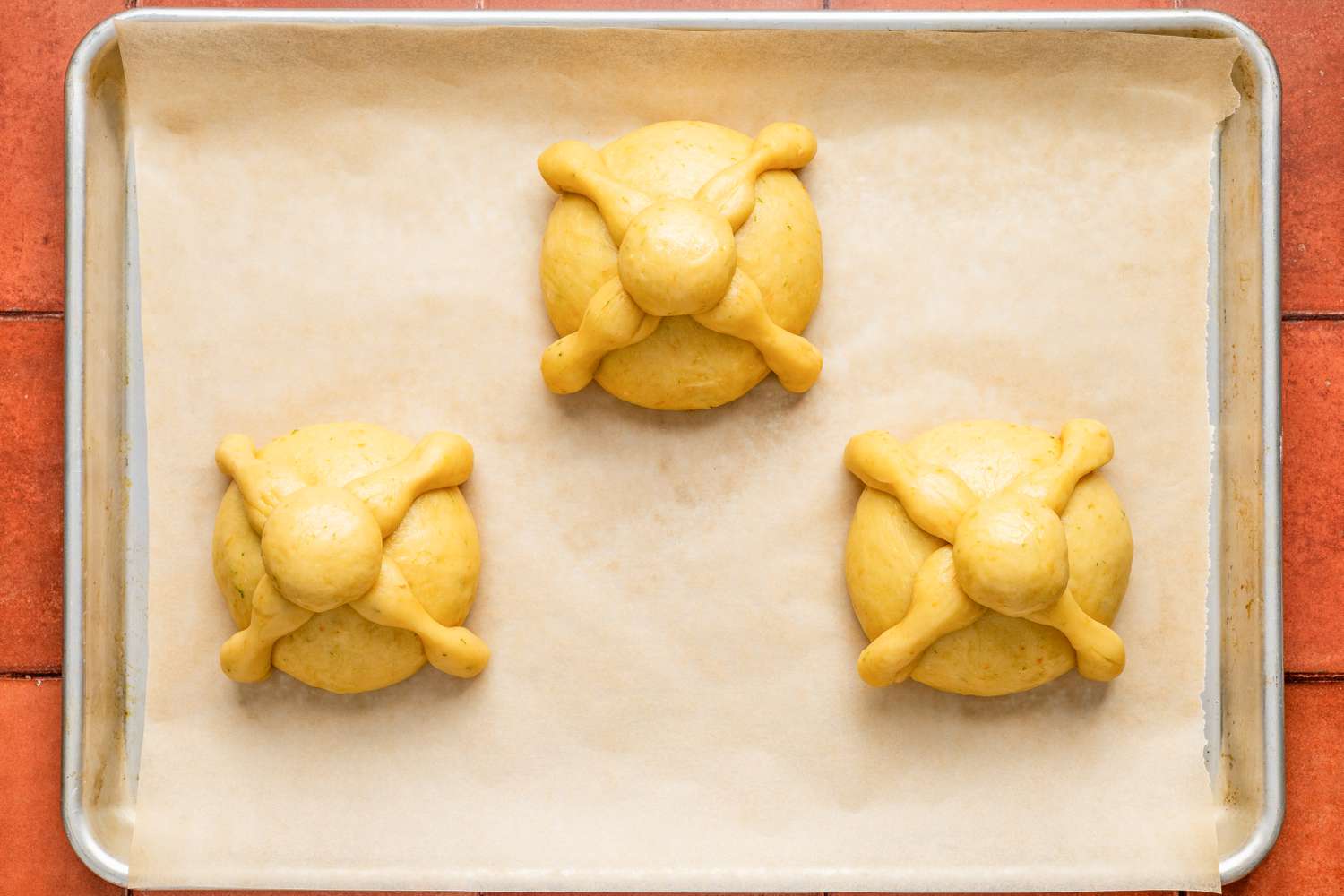 Pan de muerto after resting for 1 1/2 to 2 hours on the baking sheet