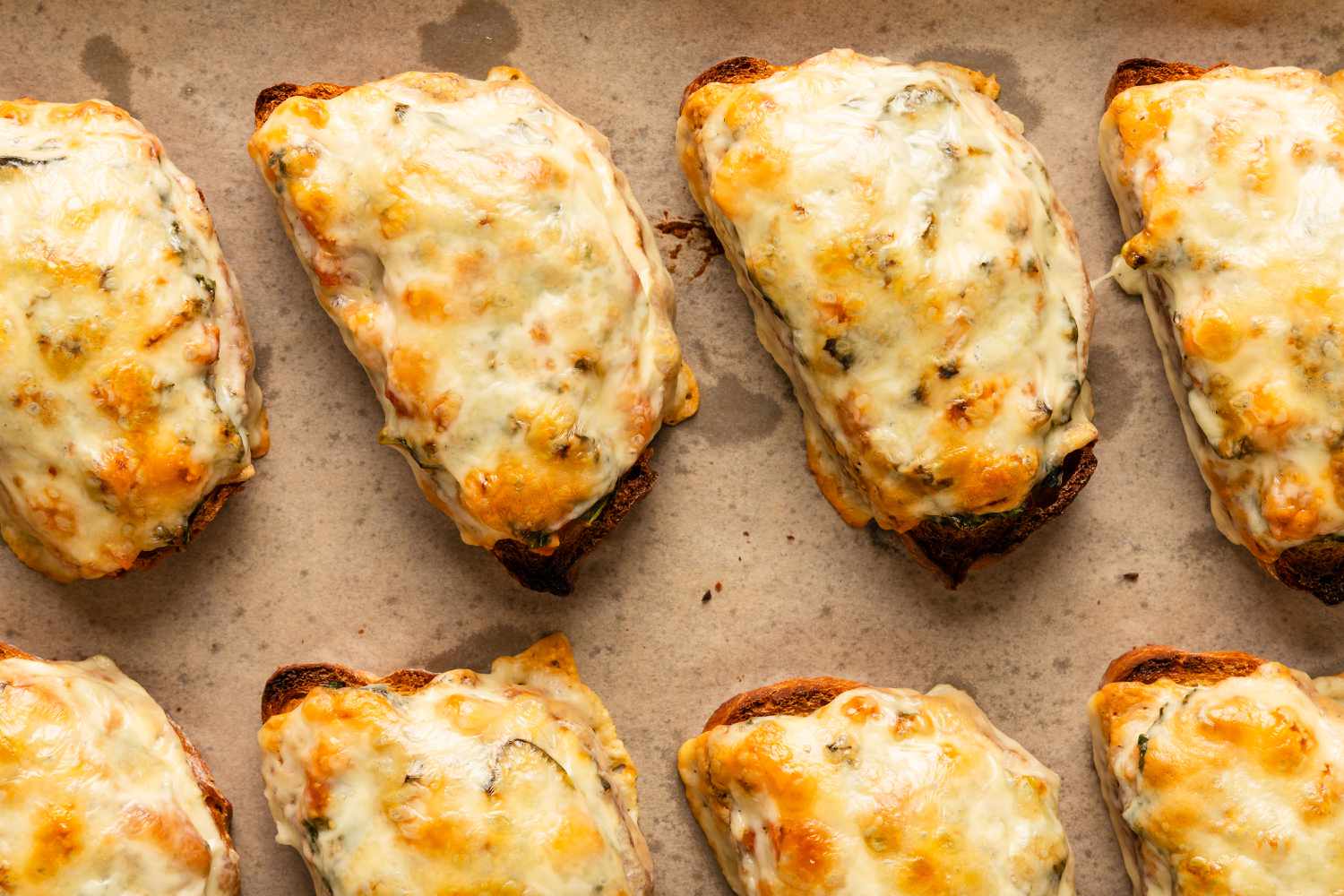close up view of several Soupy Toasts on a parchment lined sheet pan