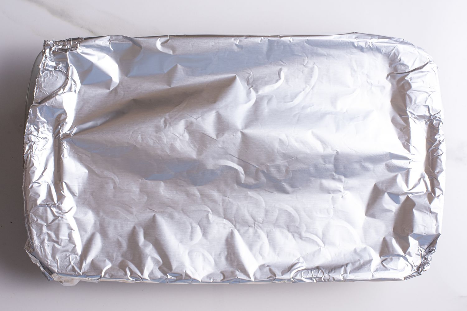baking pan covered with alumnium foil for greek lemon potatoes recipe
