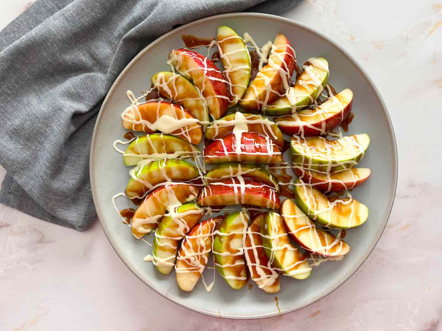 Drizzle caramel and chocolate on apples