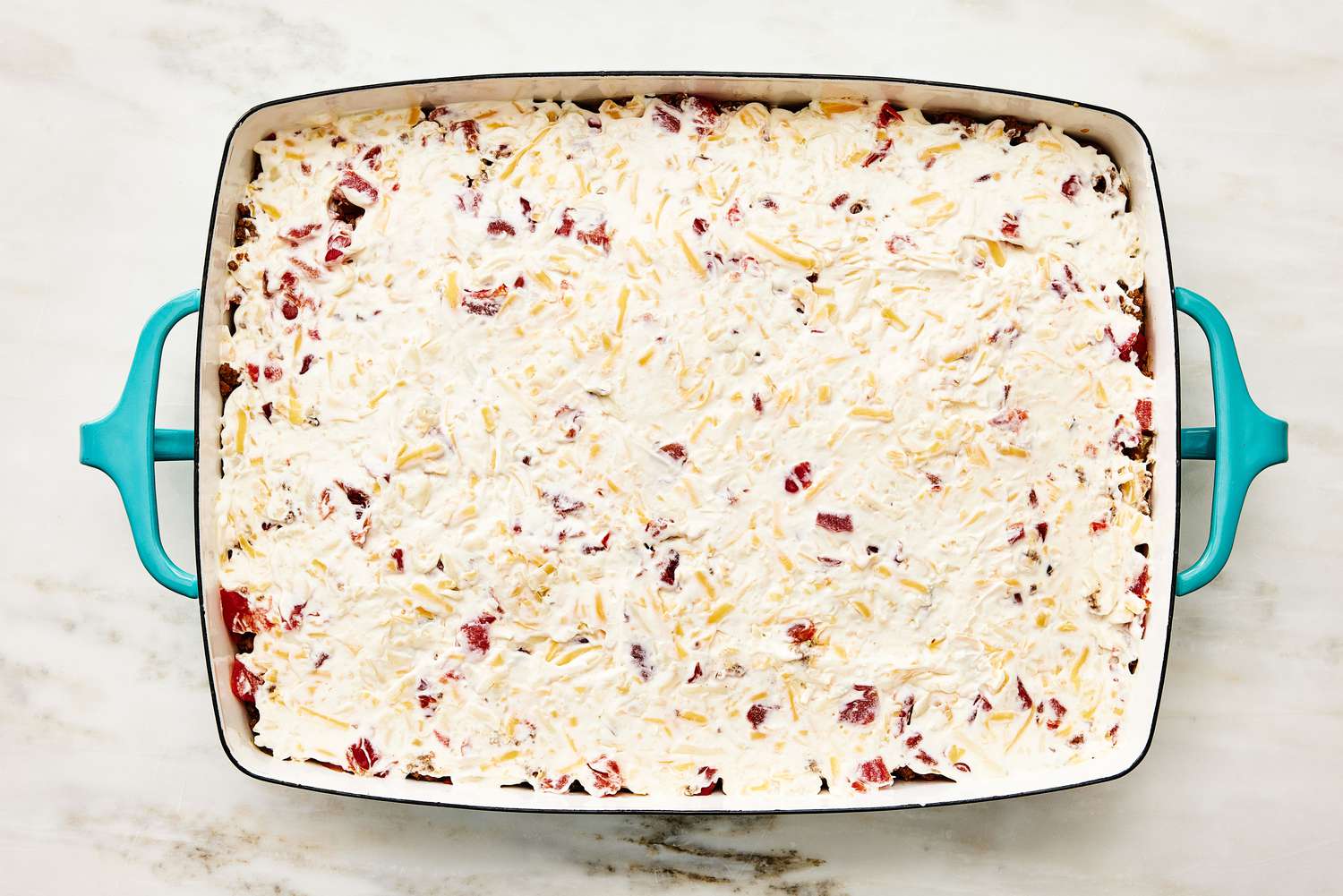 creamy topping added to the top of the casserole for Cattle Drive Casserole