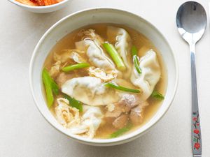 Overhead view of a bowl of beef soup with dumplings.