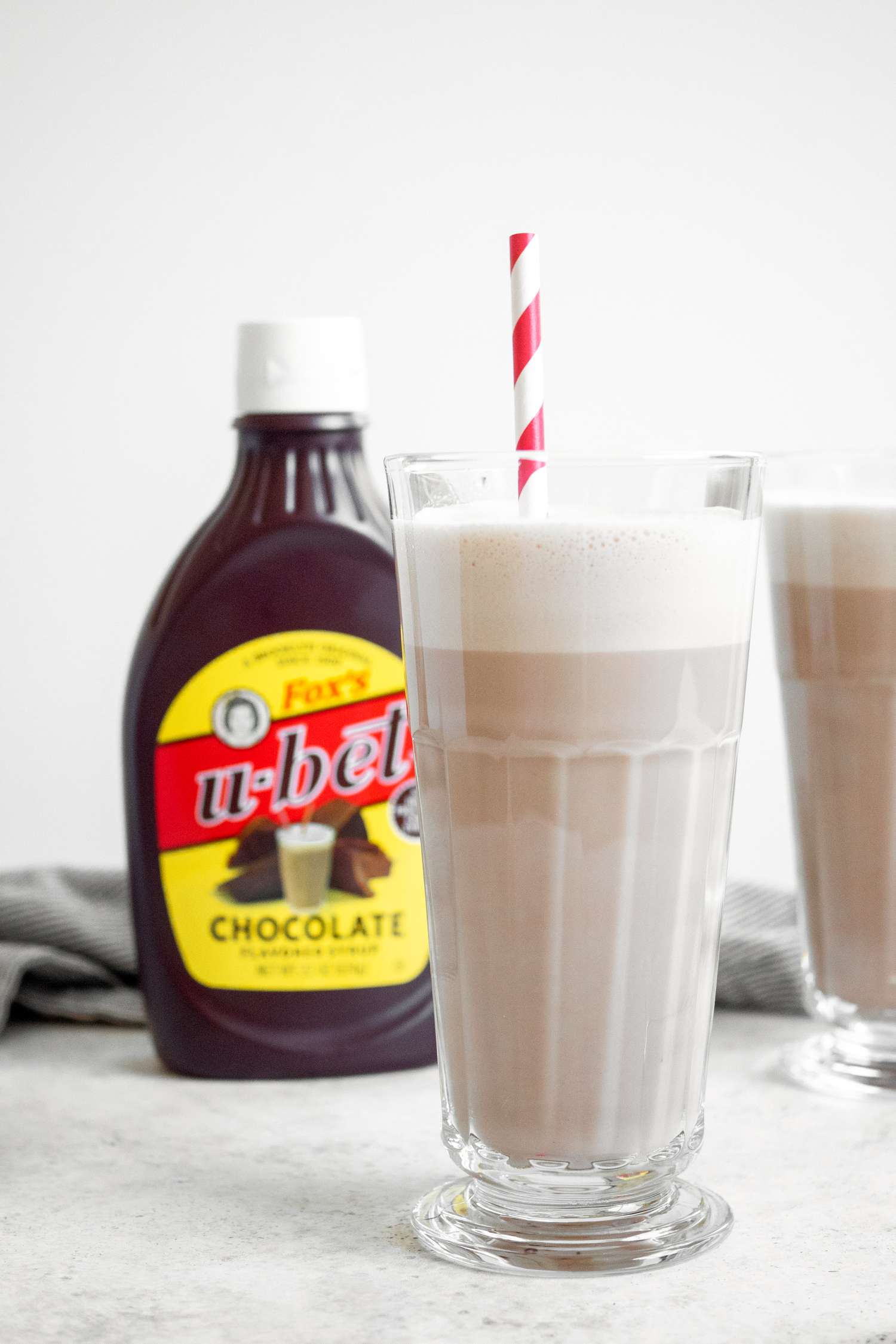Glass of Egg Cream with Chocolate Sauce in Background
