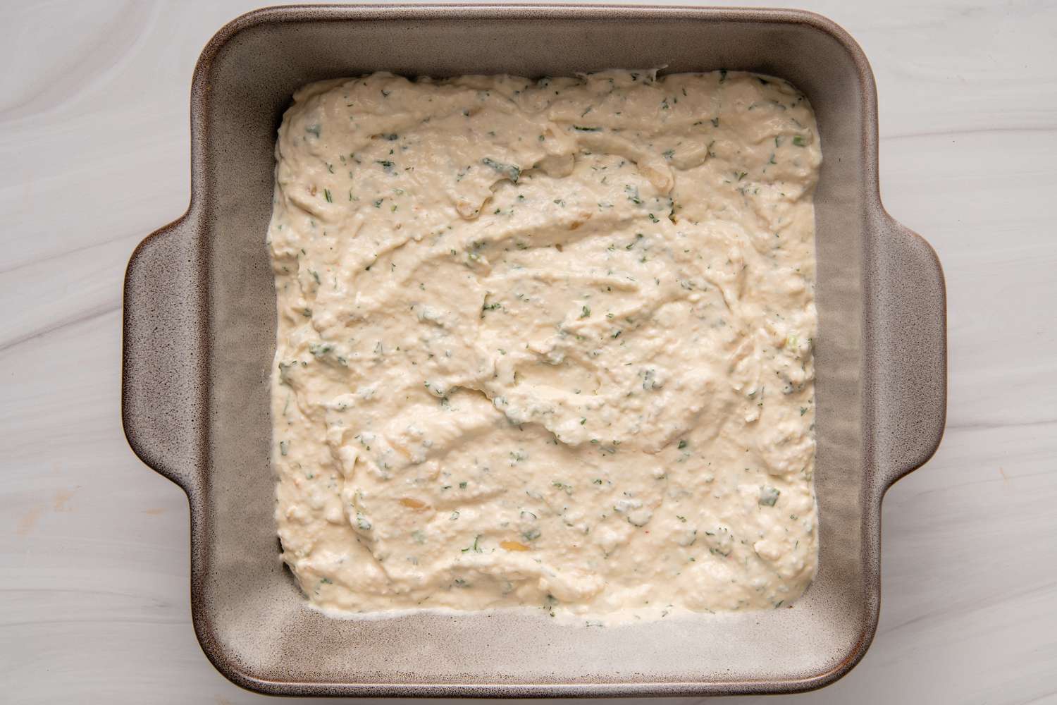 Square pan filled with a crab dip recipe
