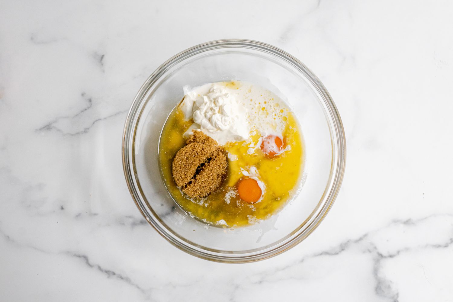 Bowl of Wet Ingredients (Brown Sugar, Eggs, Sour Cream, etc) for Apple Fritter Bread Recipe