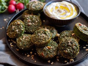 Kuku Sabzi on platter with yogurt dip.