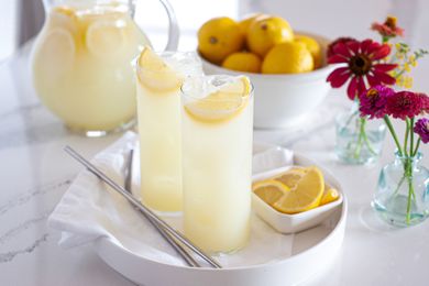 Homemade lemonade in tall glasses on a tray.