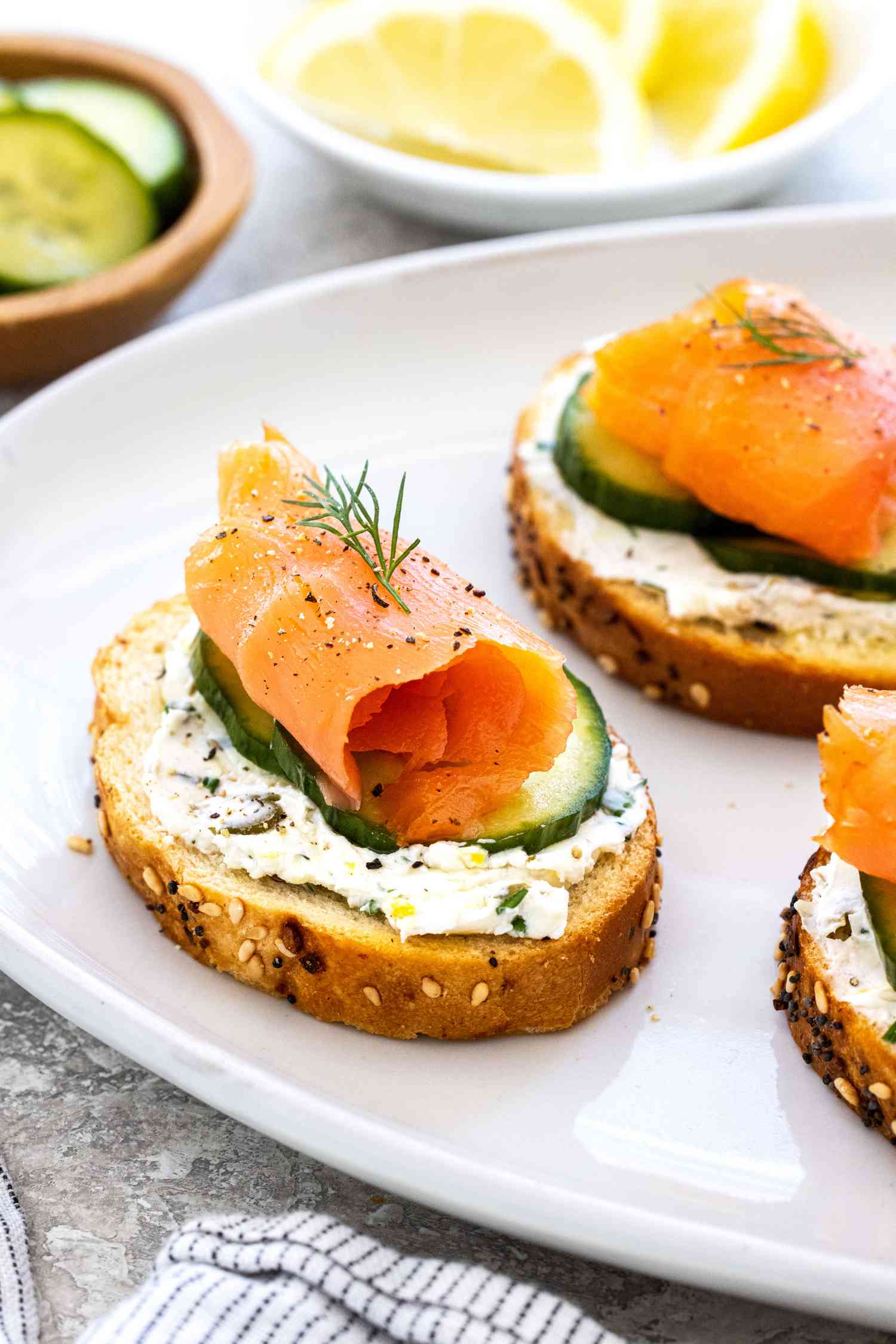 Close up of a platter of smoke salmon and herby cream cheese crostini 