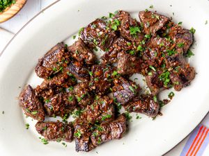 Overhead view of a white platter of Garlic Butter Steak Bites
