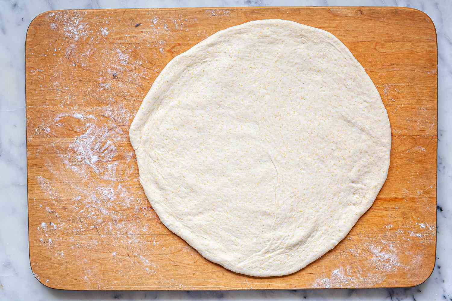 Dough rolled into a circle for Chicago-Style Deep Dish Pizza.