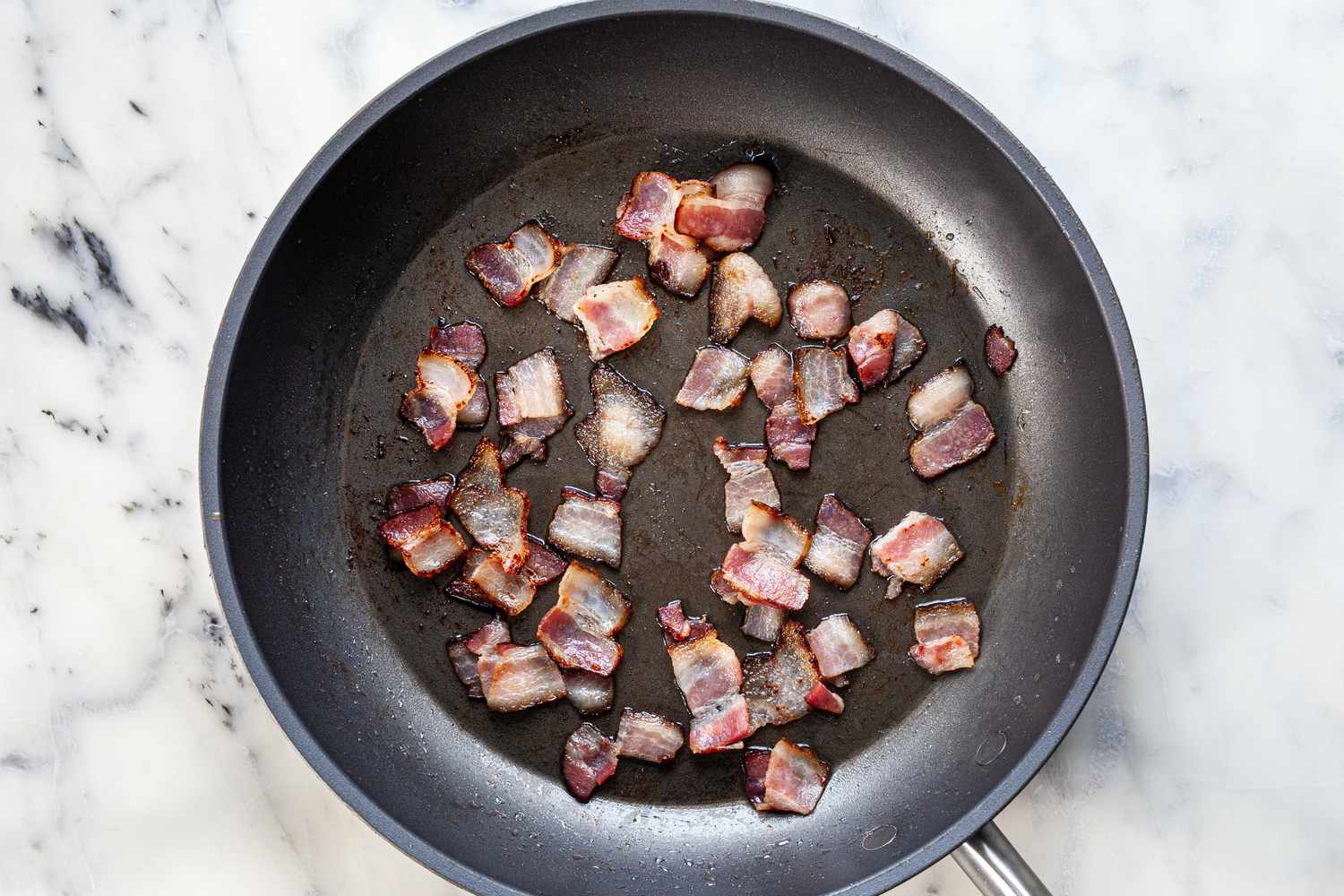 Bacon cooking in skillet.