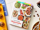 Cookbook titled Repertoire by Jessica Battilana displayed on a table with food items nearby