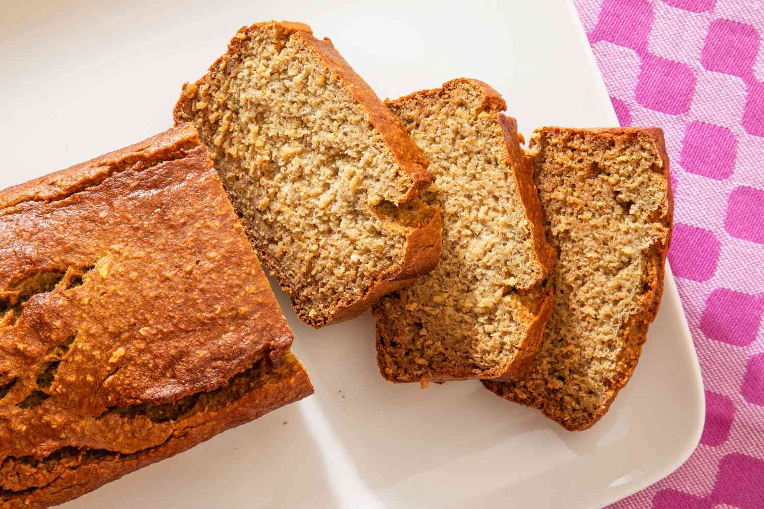 5-Ingredient Blender Banana Bread on a platter, three slices cut