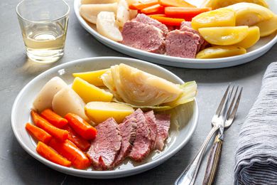 New England Boiled Dinner on platter and a plate at a dinner table