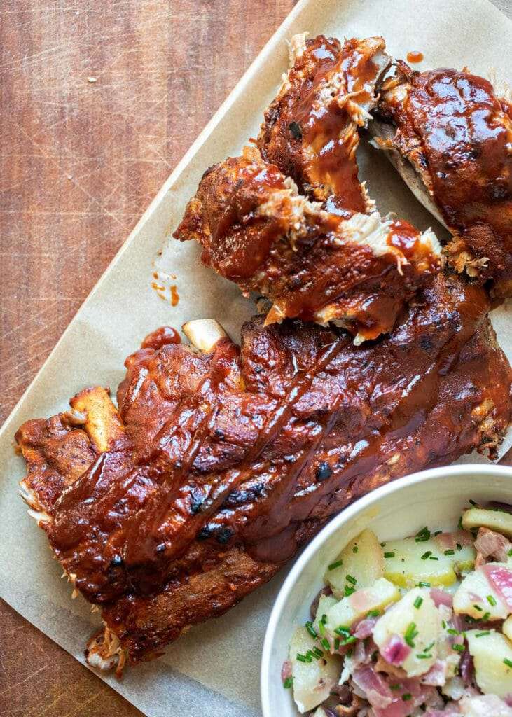 Instant Pot BBQ Ribs Recipe on a platter with potato salad