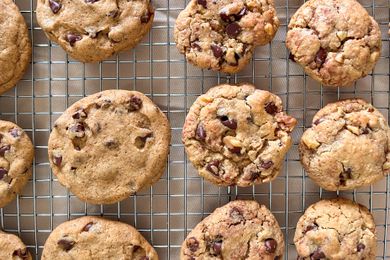 Twelve Neiman Marcus chocolate chip cookies sitting on a wire rack. 