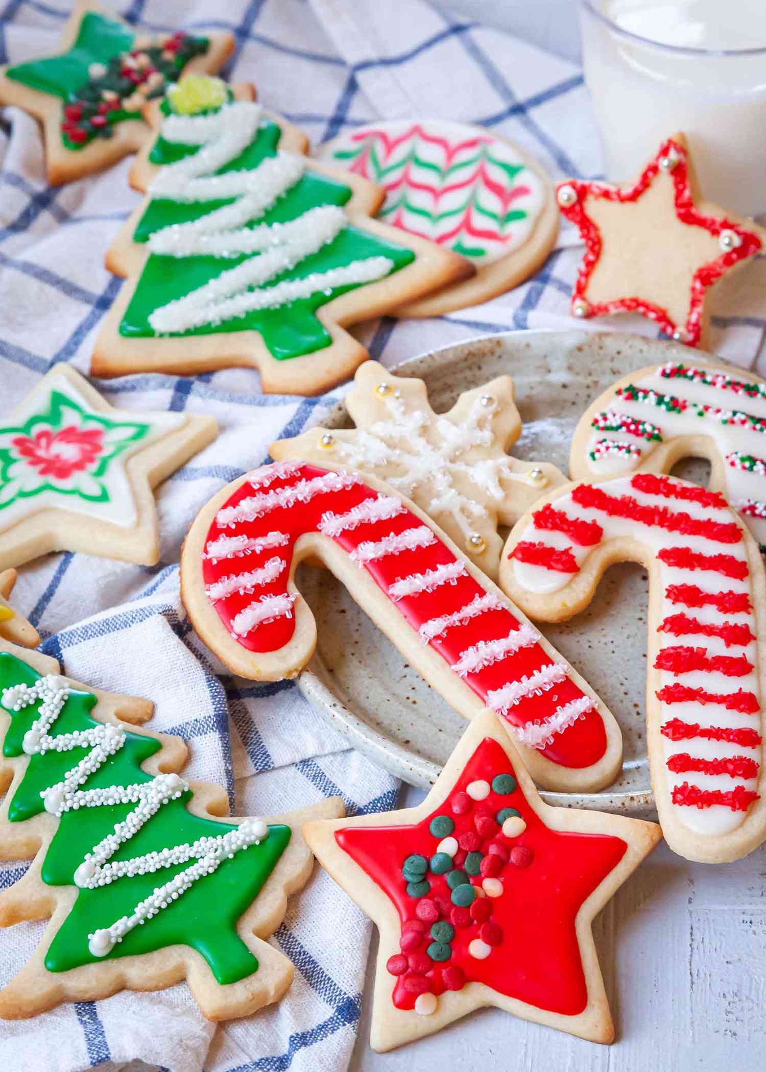 A variety of holiday cookies decorated with sprinkles and Easy Royal Icing recipe.