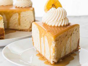 Easy Banoffee Cheesecake Pie - slice of pie with mound of whipped cream and banana slice