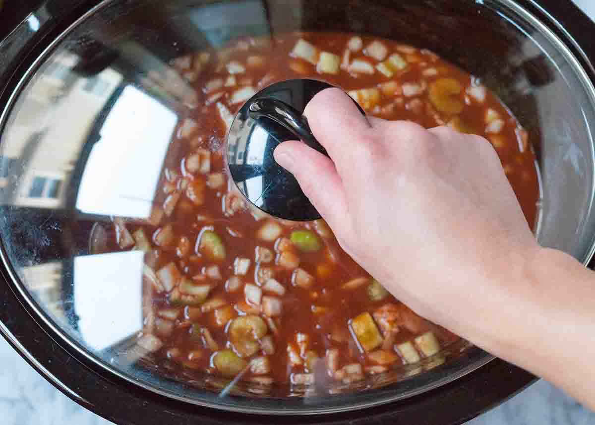 Cover the slow cooker chicken chili with a lid for cooking