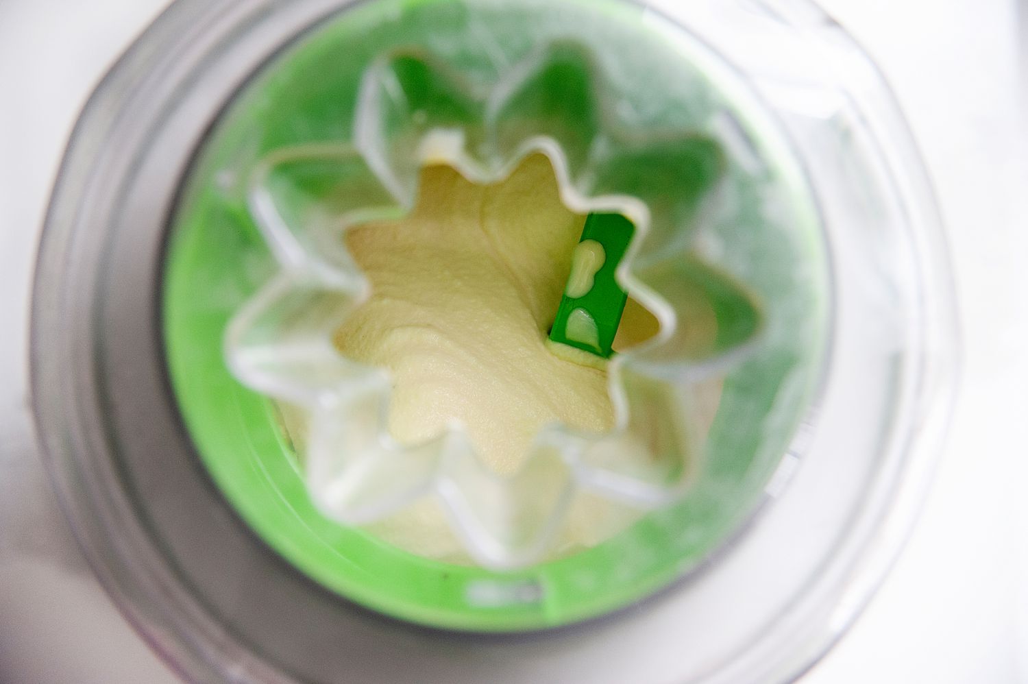 Processing mint chocolate chip ice cream in an ice cream maker.