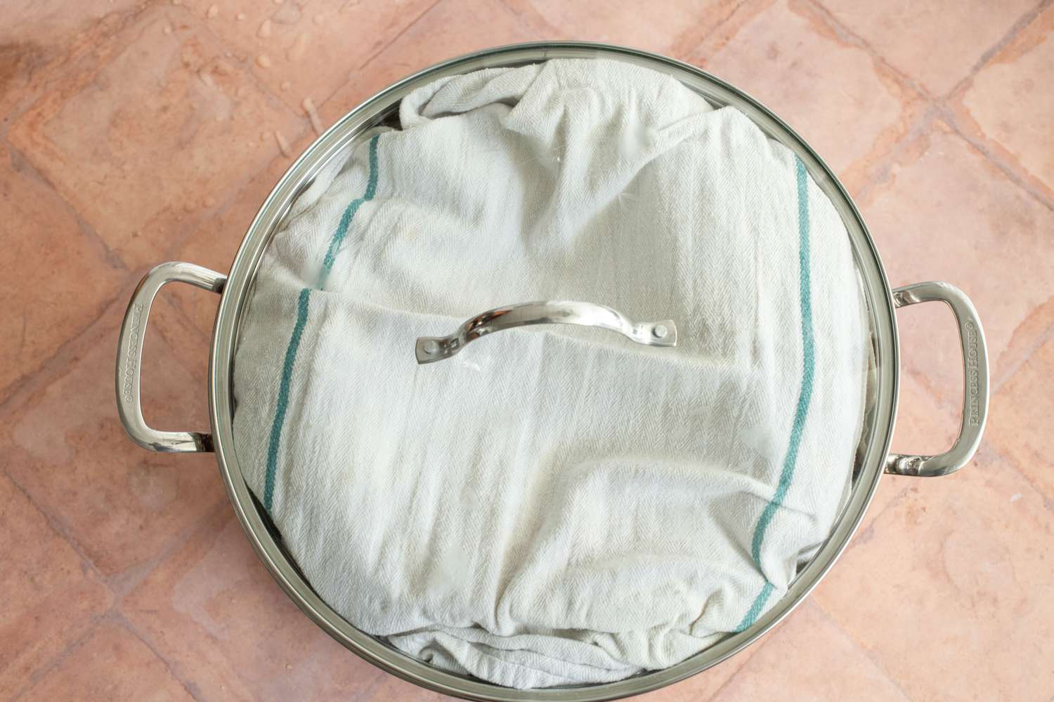 Steamer Covered in a Kitchen Towel and then the Top to the Pot for Chicken Tamales Recipe