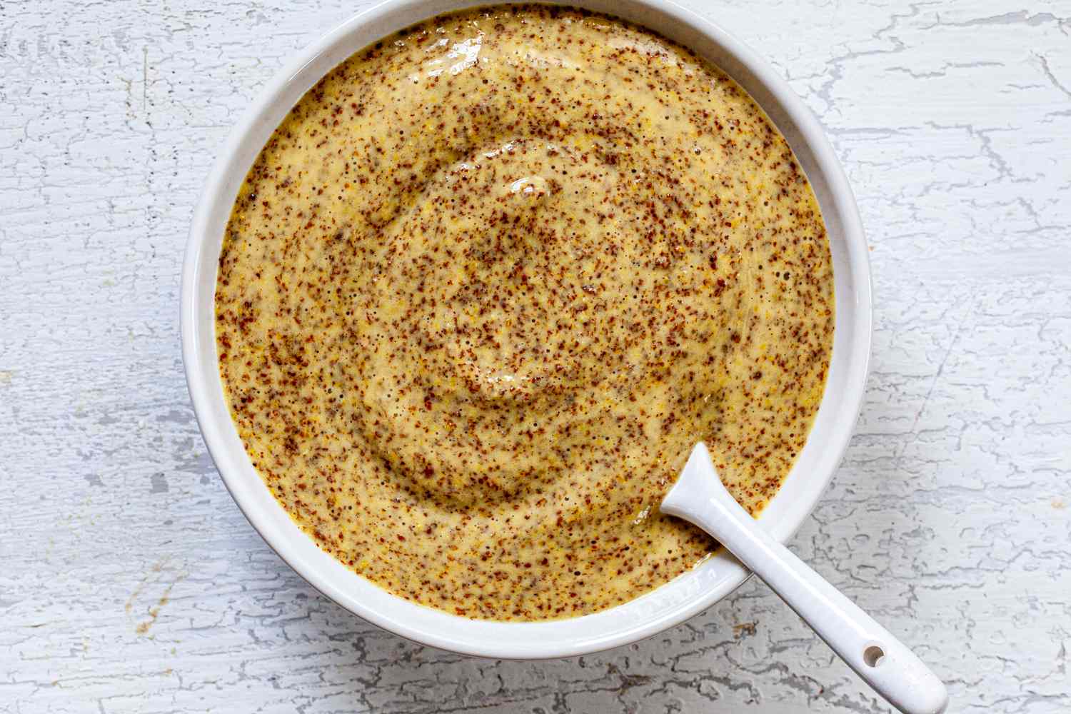 A bowl of coarse-ground Dijon mustard.