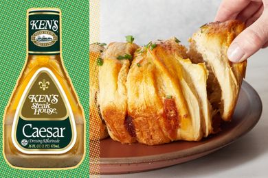 Caesar dressing bottle next to sliced pullapart bread