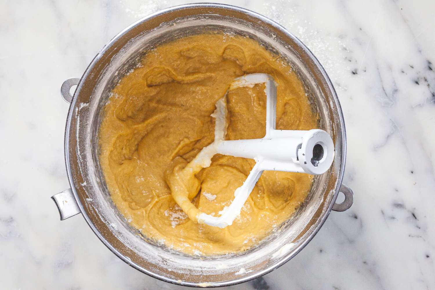 Mixing ingredients in a mixer to make the ultimate brioche buns for hamburgers.