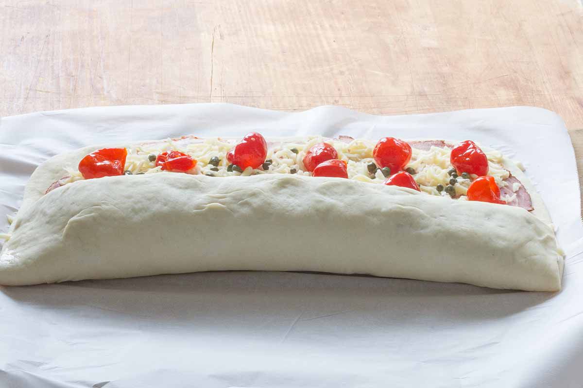Roll up the stromboli with the meats and cheese inside