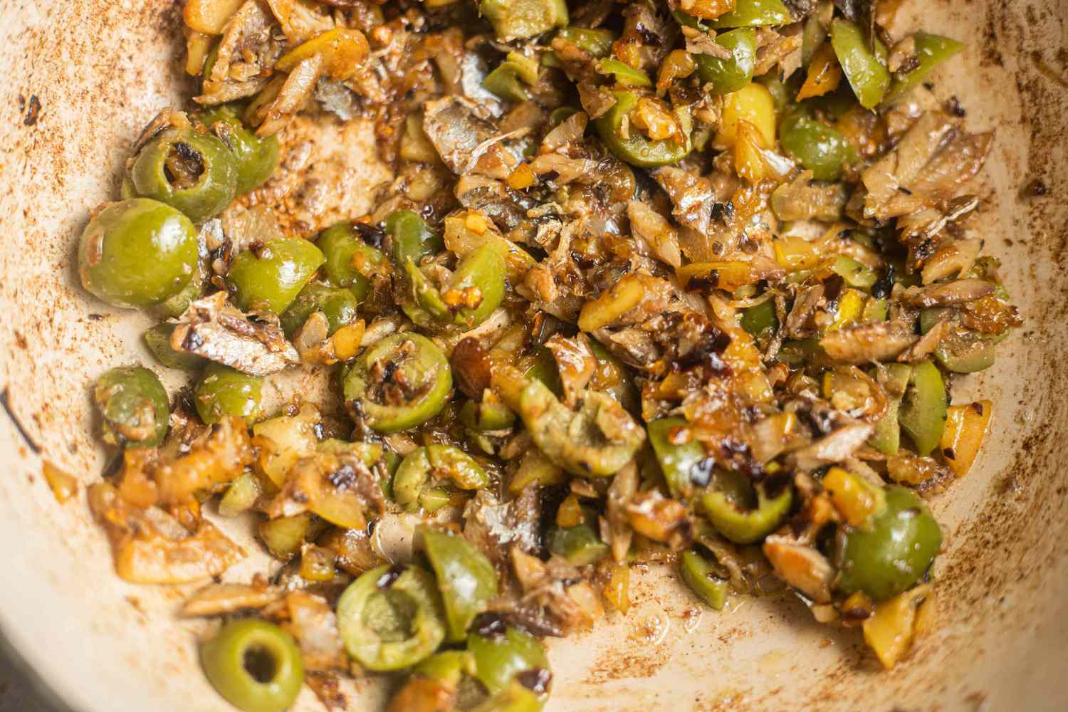 Sardines and Olives Added to Pot With Lemon Pieces