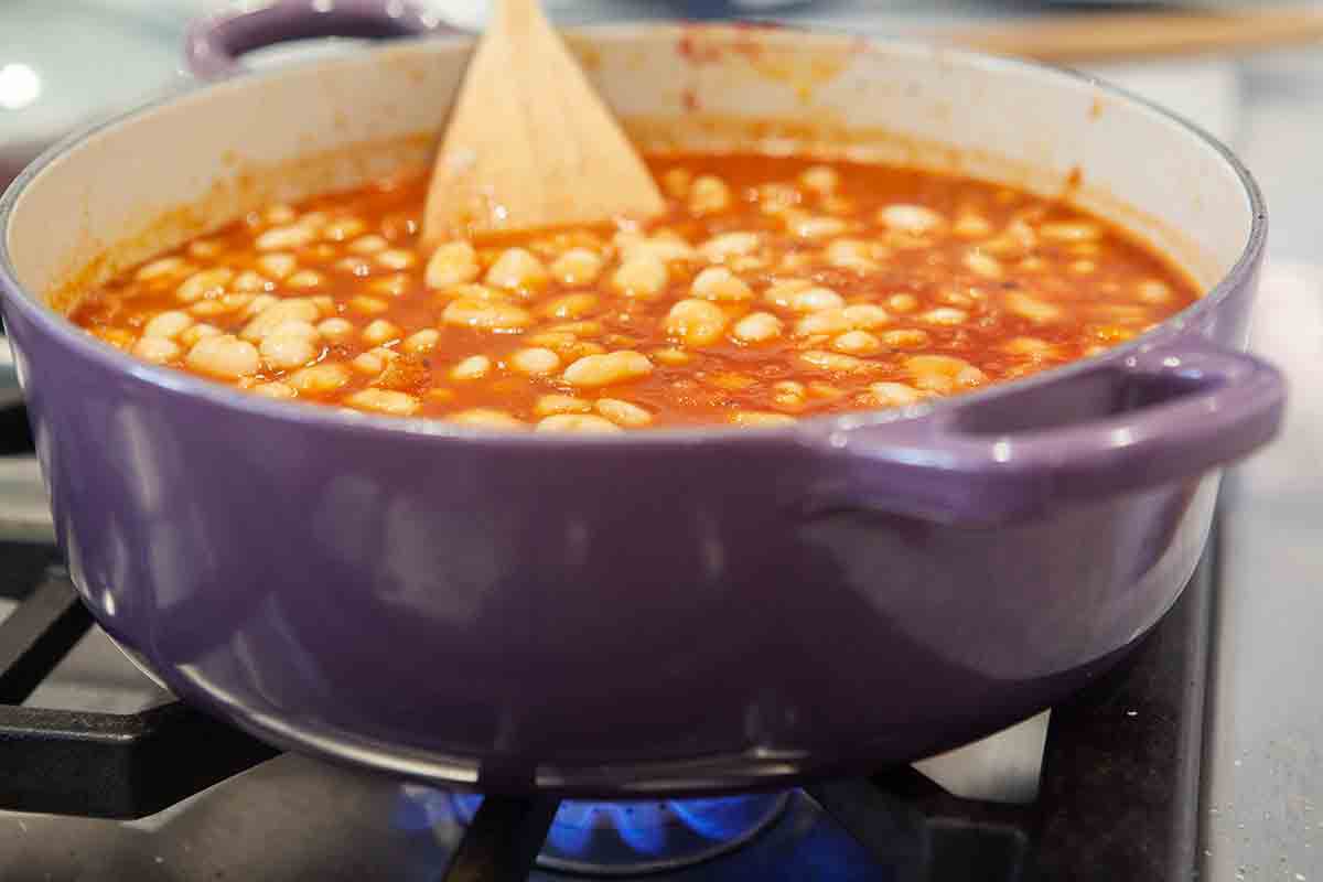 beans added to tomato sauce in pot