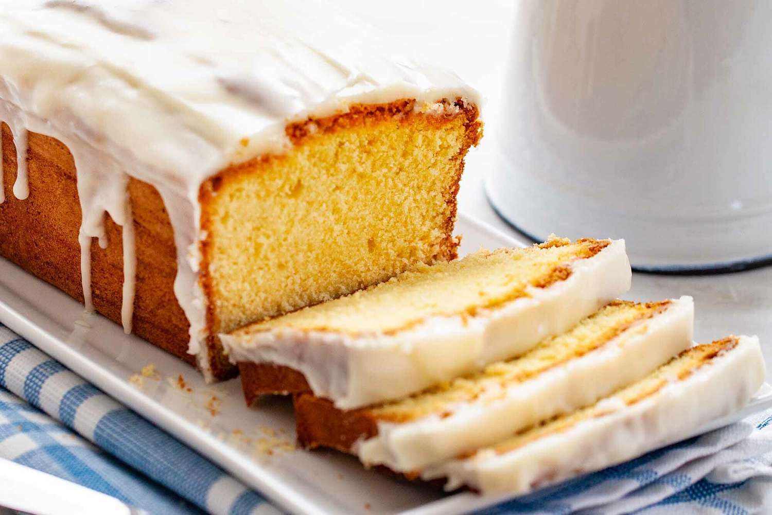 Vanilla Pound Cake sliced on a plate with icing