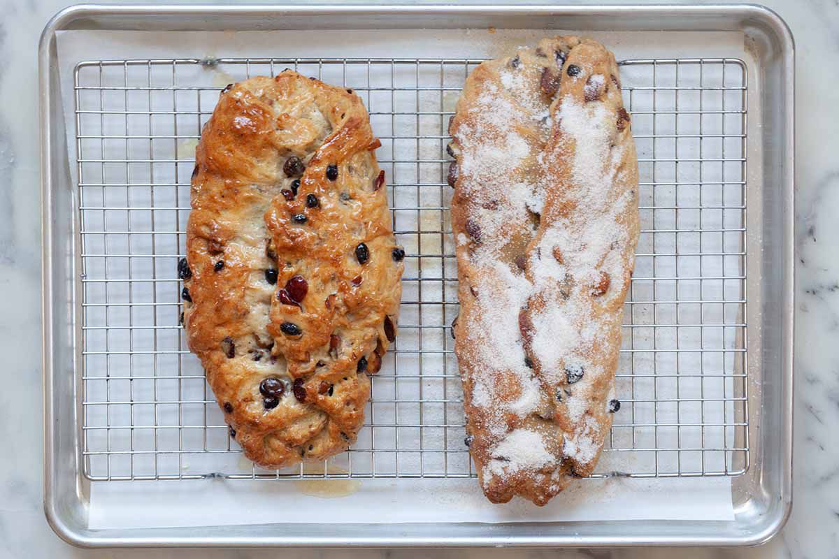 Christmas Stollen on a baking rack coated in sugar.
