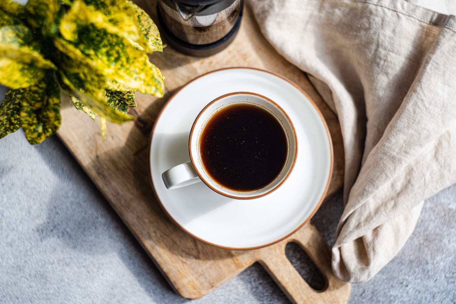 Overhead shot of a cup of coffee sitting on a matching saucer