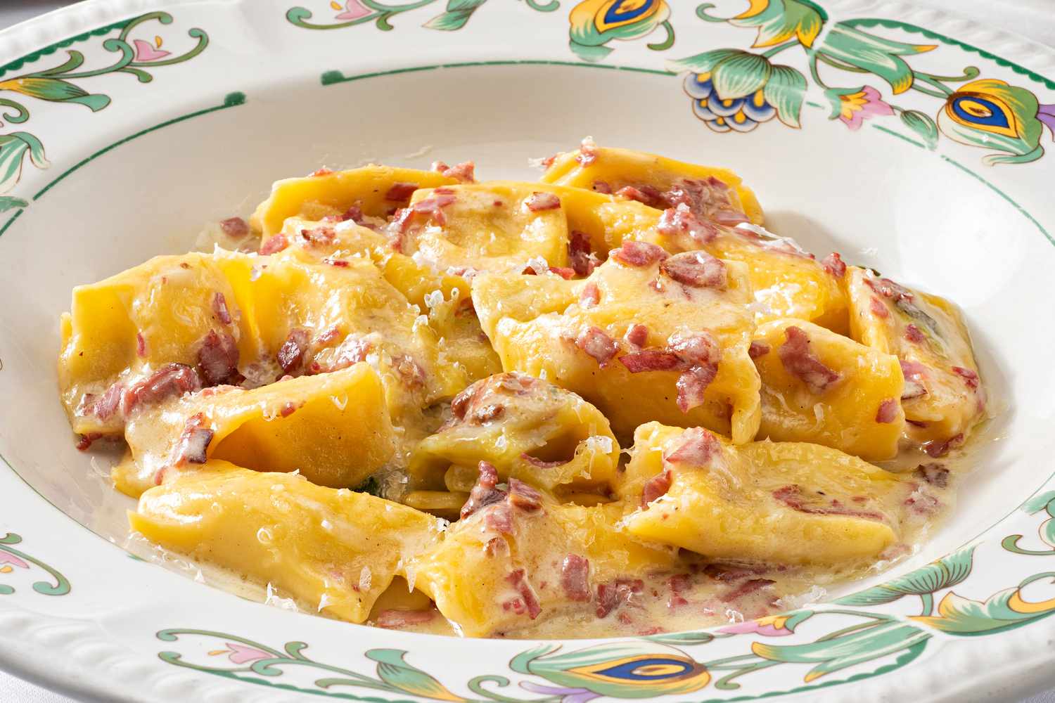 A close up of a bowl of rigatoni carbonara