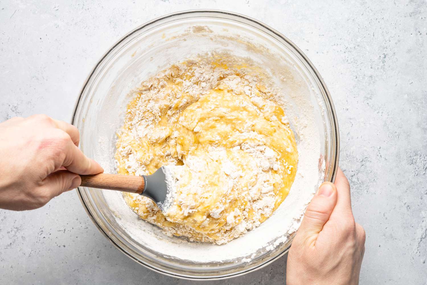 Flour Added to Bowl of Mashed Bananas and Mixed in Using a Spatula for Banana Bread Recipe
