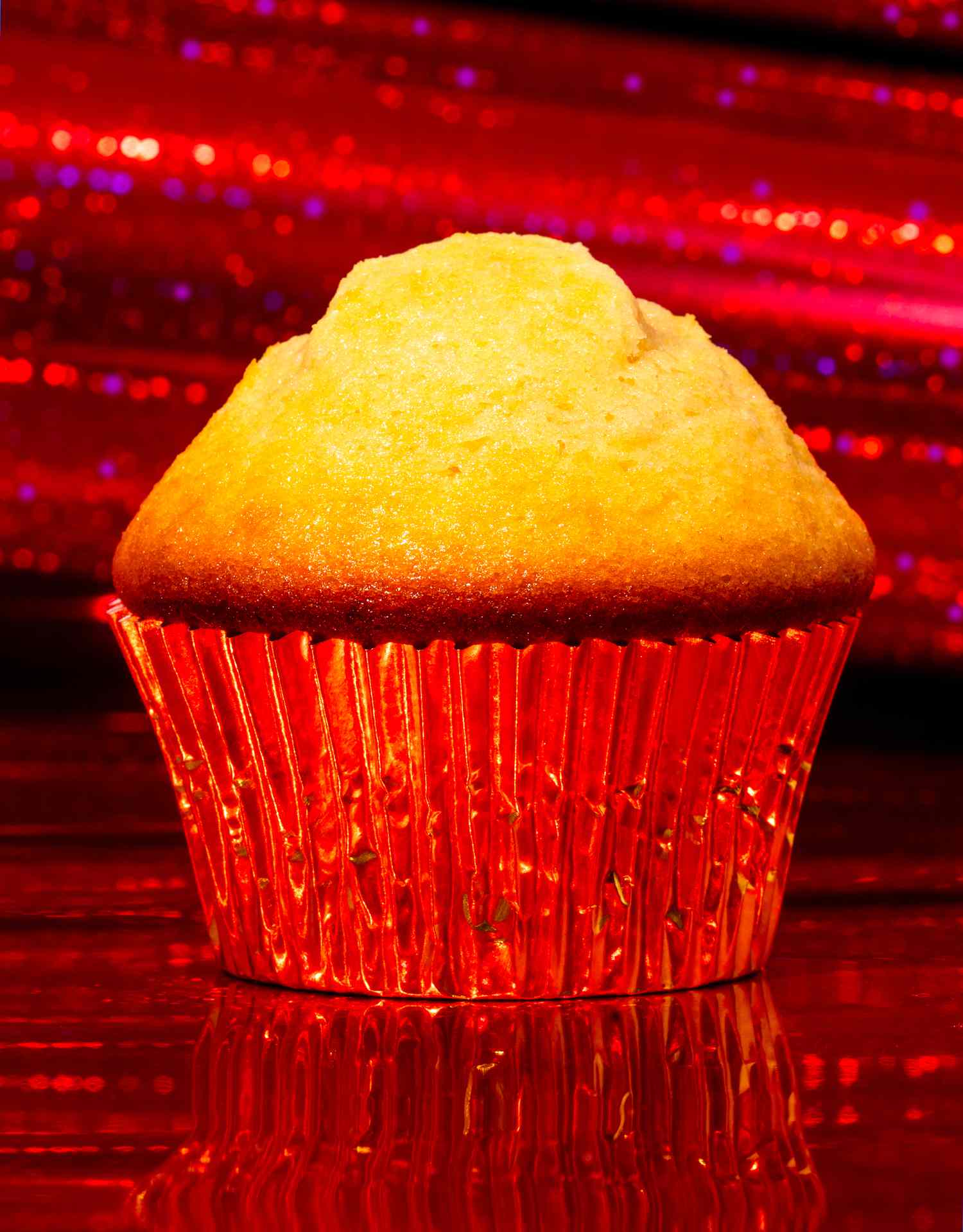 Mantecadas in Red Shiny Cupcake Liner, Surrounded by a Sparkly Red Background