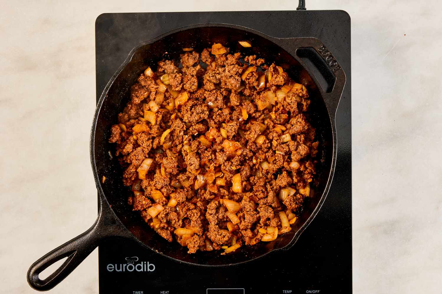 cooked ground beef and onions in the cast iron skillet for crispy ground beef recipe