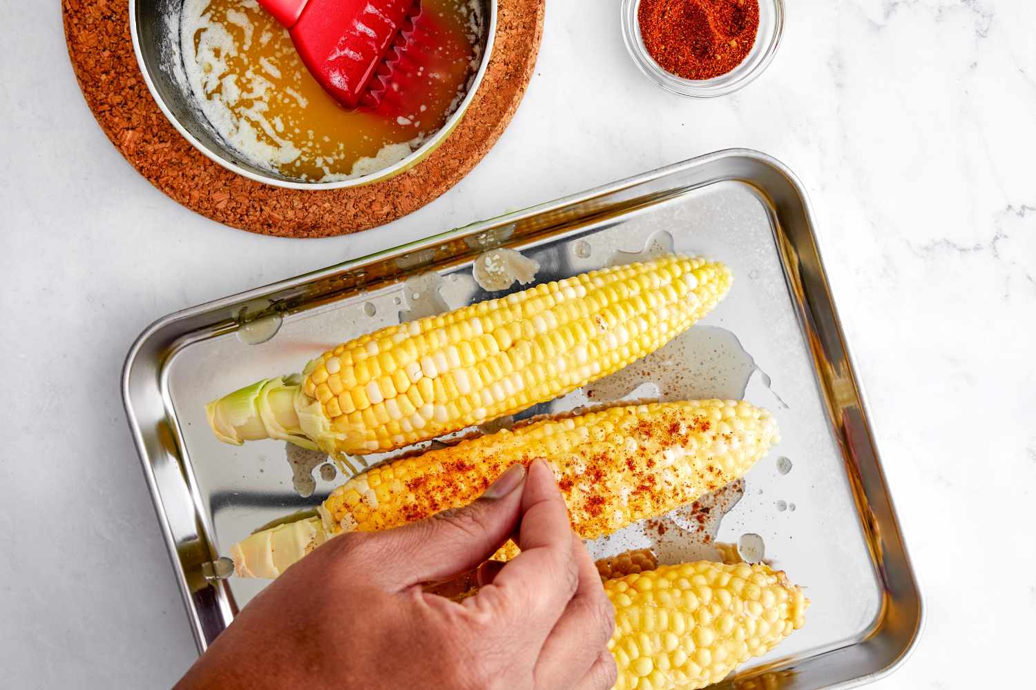 Cajun Spice Sprinkled on Corn for Grilled Cajun Corn Recipe